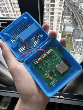 Open blue DoggyBell detector enclosure revealing the circuit board, wiring and internal components.