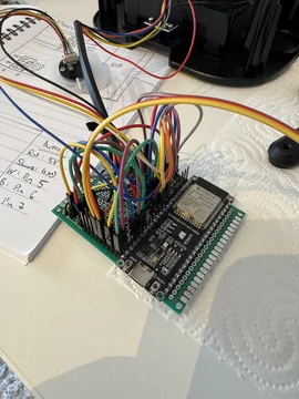 DoggyBell electronics test setup with a development board and multicolored jumper wires.